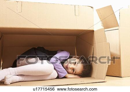 Stock Photograph - Little girl in packing case. Fotosearch