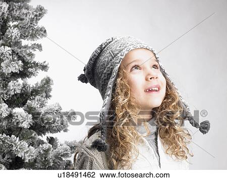 Little girl next to a fir-tree View Large Photo Image Stock Image - Little girl next to a fir-tree. Fotosearch