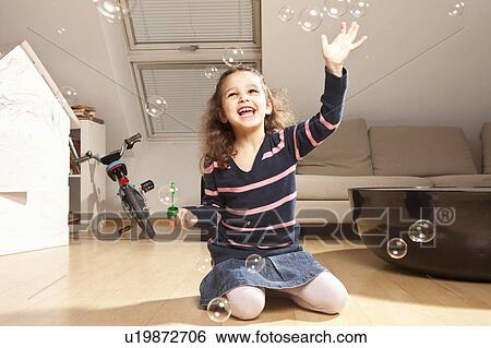 Little girl playing with bubbles View Large Photo Image Stock Photograph - Little girl playing with bubbles. Fotosearch