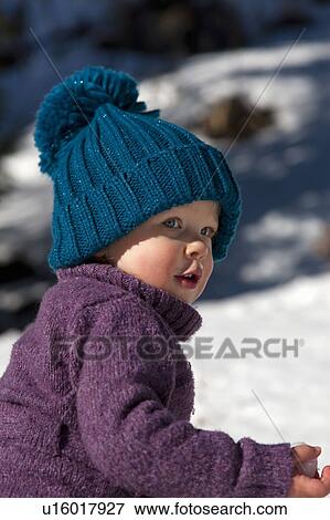 Little girl with big hat playing in snow View Large Photo Image Stock Photo - Little girl with big hat playing in snow. Fotosearch