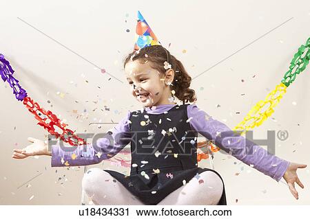Stock Image - Little girl with confetti. Fotosearch