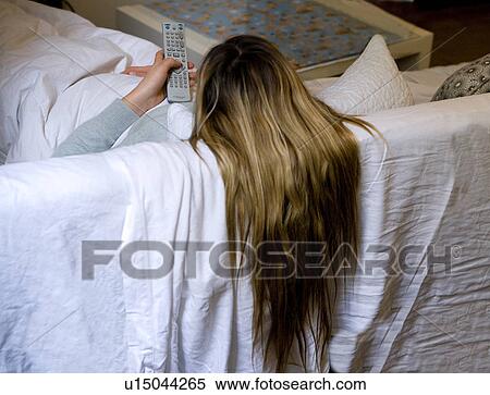 Long hair woman watch TV with remote View Large Photo Image Stock Photography - Long hair woman watch TV with remote. Fotosearch