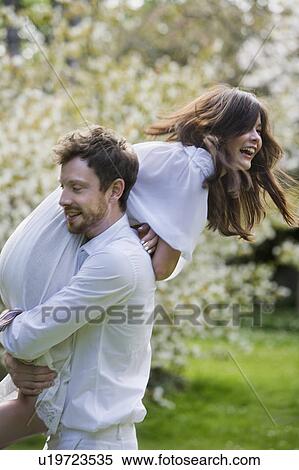 Love couple having fun in the park View Large Photo Image Stock Photography - Love couple having fun in the park. Fotosearch