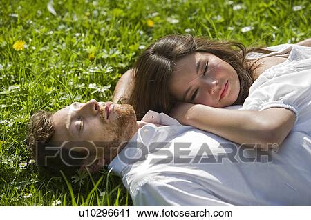 Love couple relaxing in a park View Large Photo Image Stock Image - Love couple relaxing in a park. Fotosearch