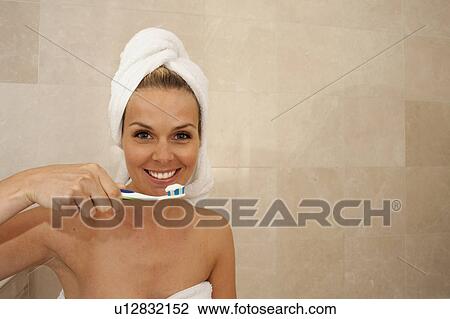 Lovely woman cleaning teeth View Large Photo Image Stock Image - Lovely woman cleaning teeth. Fotosearch