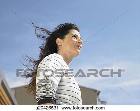 Low angle portrait of woman against sky, Alicante, Spain, View Large Photo Image Stock Image - Low angle portrait of woman against sky, Alicante, Spain,. Fotosearch