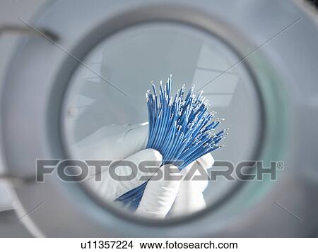 Magnified view of hands holding cables View Large Photo Image Picture - Magnified view of hands holding cables. Fotosearch