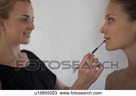 Makeup artist applying lipstick to model using lip brush View Large Photo Image Stock Image - Makeup artist applying lipstick to model using lip brush. Fotosearch