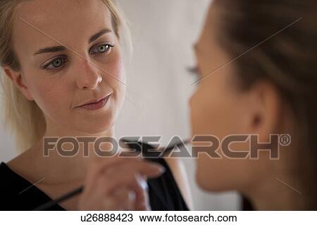 Makeup artist applying lipstick to model with lip brush View Large Photo Image Stock Image - Makeup artist applying lipstick to model with lip brush. Fotosearch