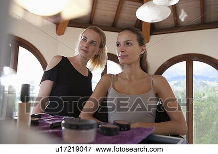 Makeup artist & model looking to mirror View Large Photo Image Stock Photo - Makeup artist & model looking to mirror. Fotosearch