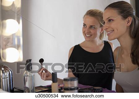 Makeup artist & model smiling at mirror View Large Photo Image Picture - Makeup artist & model smiling at mirror. Fotosearch