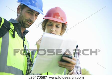 Stock Photo - Male and female Architects in meeting. Fotosearch