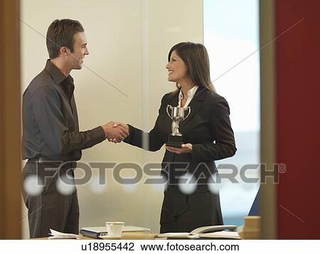 Man and woman holding trophies View Large Photo Image Stock Image - Man and woman holding trophies. Fotosearch