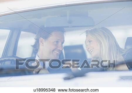 Man and woman sitting in a car View Large Photo Image Stock Photo - Man and woman sitting in a car. Fotosearch