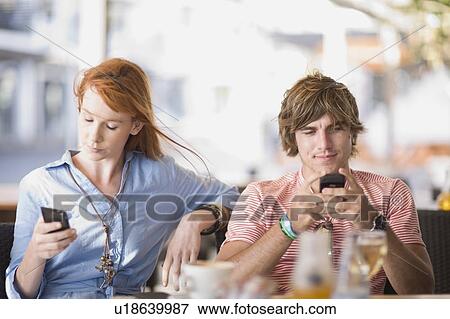 Man and woman writing sms View Large Photo Image Stock Photo - Man and woman writing sms. Fotosearch