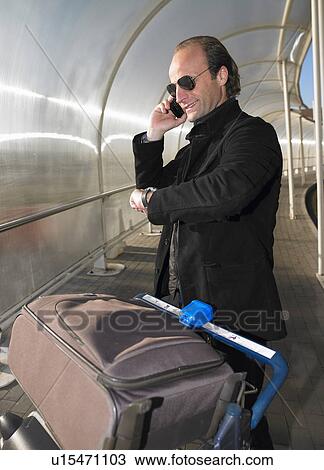 Stock Image - Man at the airport on the phone. Fotosearch