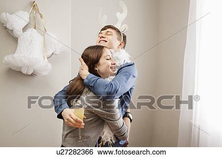 Stock Photograph - Man embracing girlfriend. Fotosearch