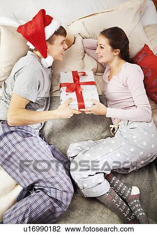 Man gives christmas present to partner View Large Photo Image Stock Image - Man gives christmas present to partner. Fotosearch