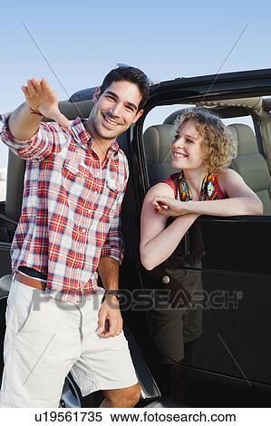 Man giving woman in jeep directions View Large Photo Image Stock Photography - Man giving woman in jeep directions. Fotosearch