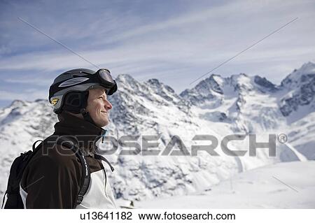 Man hiking up snowy mountain View Large Photo Image Stock Image - Man hiking up snowy mountain. Fotosearch