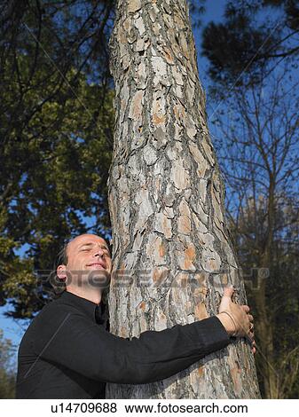 Man hugging a tree View Large Photo Image Stock Photo - Man hugging a tree. Fotosearch