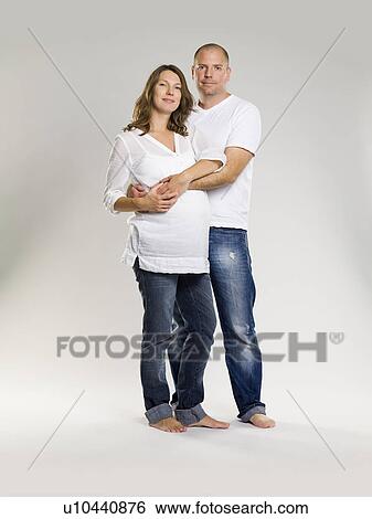 Stock Photograph - Man hugging pregnant wife. Fotosearch