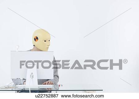 Man in crash dummy mask working at computer View Large Photo Image Stock Photo - Man in crash dummy mask working at computer. Fotosearch