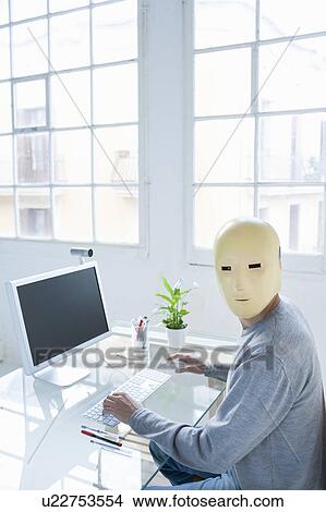 Man in crash test dummy mask in an office View Large Photo Image Picture - Man in crash test dummy mask in an office. Fotosearch
