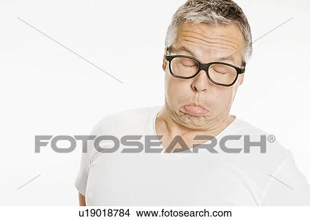 Man in eyeglasses making a funny face View Large Photo Image Picture - Man in eyeglasses making a funny face. Fotosearch