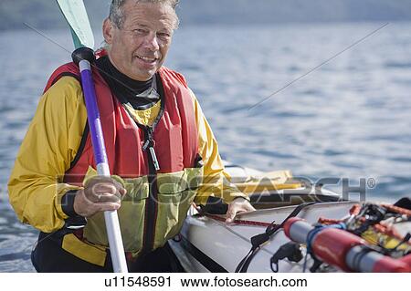 Stock Image - Man kayaking. Fotosearch