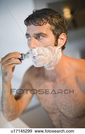 Man lathering his face in bathroom View Large Photo Image Stock Photo - Man lathering his face in bathroom. Fotosearch