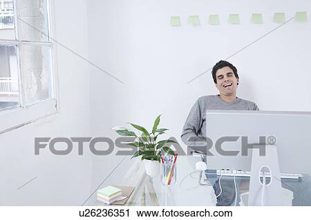 Man laughing at computer View Large Photo Image Stock Image - Man laughing at computer. Fotosearch