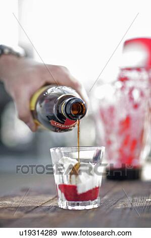 Man pouring drink into glass View Large Photo Image Stock Photo - Man pouring drink into glass. Fotosearch