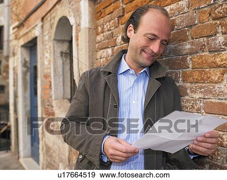 Stock Photo - Man reading a letter. Fotosearch