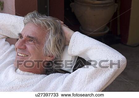 Man relaxing with hands behind head View Large Photo Image Stock Image - Man relaxing with hands behind head. Fotosearch