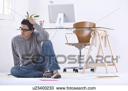Man sitting on the floor in a office thinking View Large Photo Image Stock Image - Man sitting on the floor in a office thinking. Fotosearch