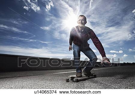 Picture - Man skating on longboard. Fotosearch
