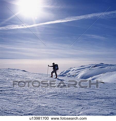 Stock Image - Man skiing on mountain. Fotosearch