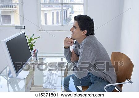 Man smiling at computer View Large Photo Image Stock Image - Man smiling at computer. Fotosearch