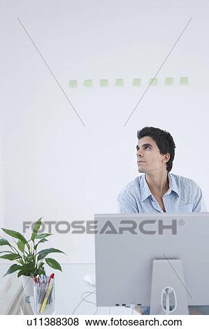 Man thinking at computer View Large Photo Image Stock Photo - Man thinking at computer. Fotosearch