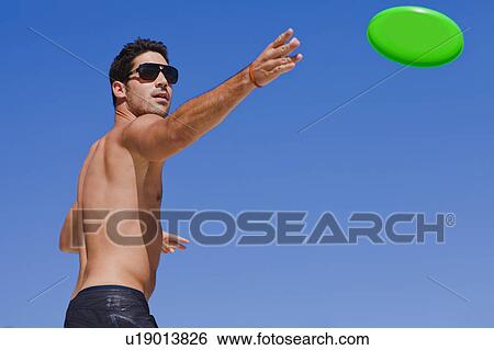 Stock Photograph - Man throwing a frisbee. Fotosearch