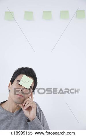 Man with 'busy' post-it note on his head View Large Photo Image Stock Photography - Man with 'busy' post-it note on his head. Fotosearch