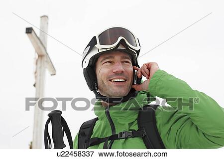 Stock Photo - Man with helmet and cellphone. Fotosearch