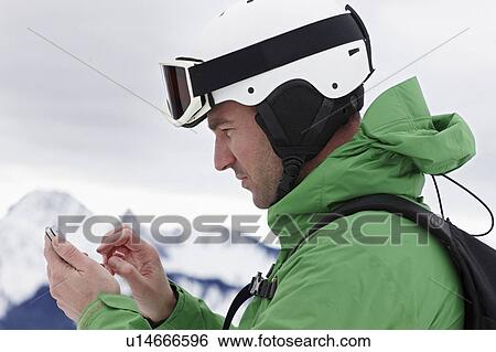 Stock Photograph - Man with Helmet and Touchphone. Fotosearch