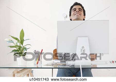 Man working at computer smiling View Large Photo Image Stock Image - Man working at computer smiling. Fotosearch