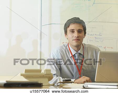 Picture - Man working at desk. Fotosearch