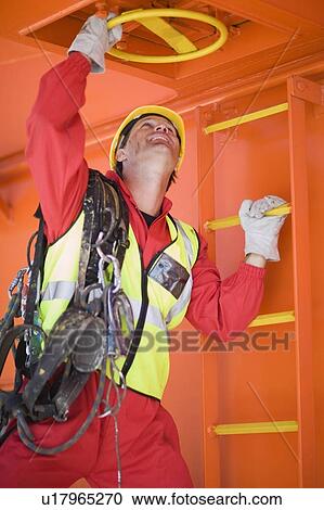 Stock Image - Man working on a ship. Fotosearch