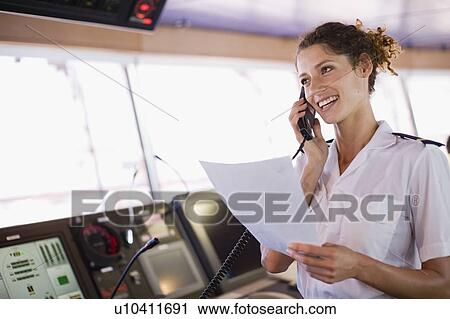 Mate of a ship doing a phone call View Large Photo Image Stock Image - Mate of a ship doing a phone call. Fotosearch