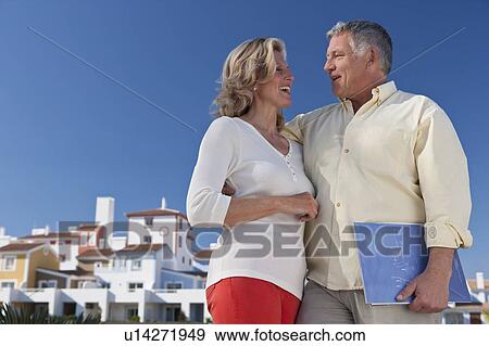 Stock Photo - Mature couple buying realestate property. Fotosearch
