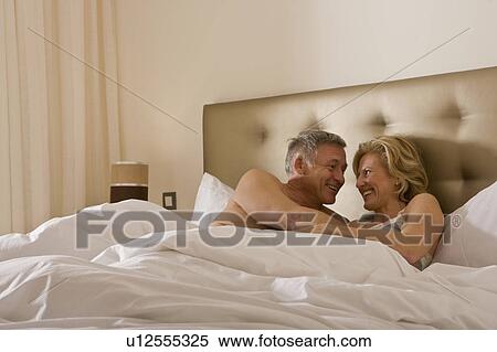 Mature couple embracing tenderly in bed View Large Photo Image Stock Photography - Mature couple embracing tenderly in bed. Fotosearch